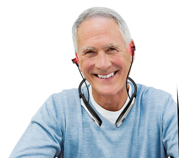 Senior man using wearable red light therapy headset for ear care and circulation support.