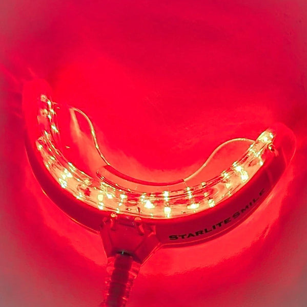 Starlite Smile red light therapy mouth tray glowing with 32 LED lights for gum health and oral care.